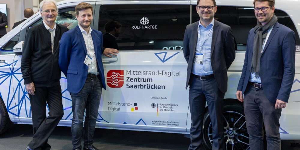 ROLFHARTGE and AWS Institut at Hannover Messe in front of the Future Car